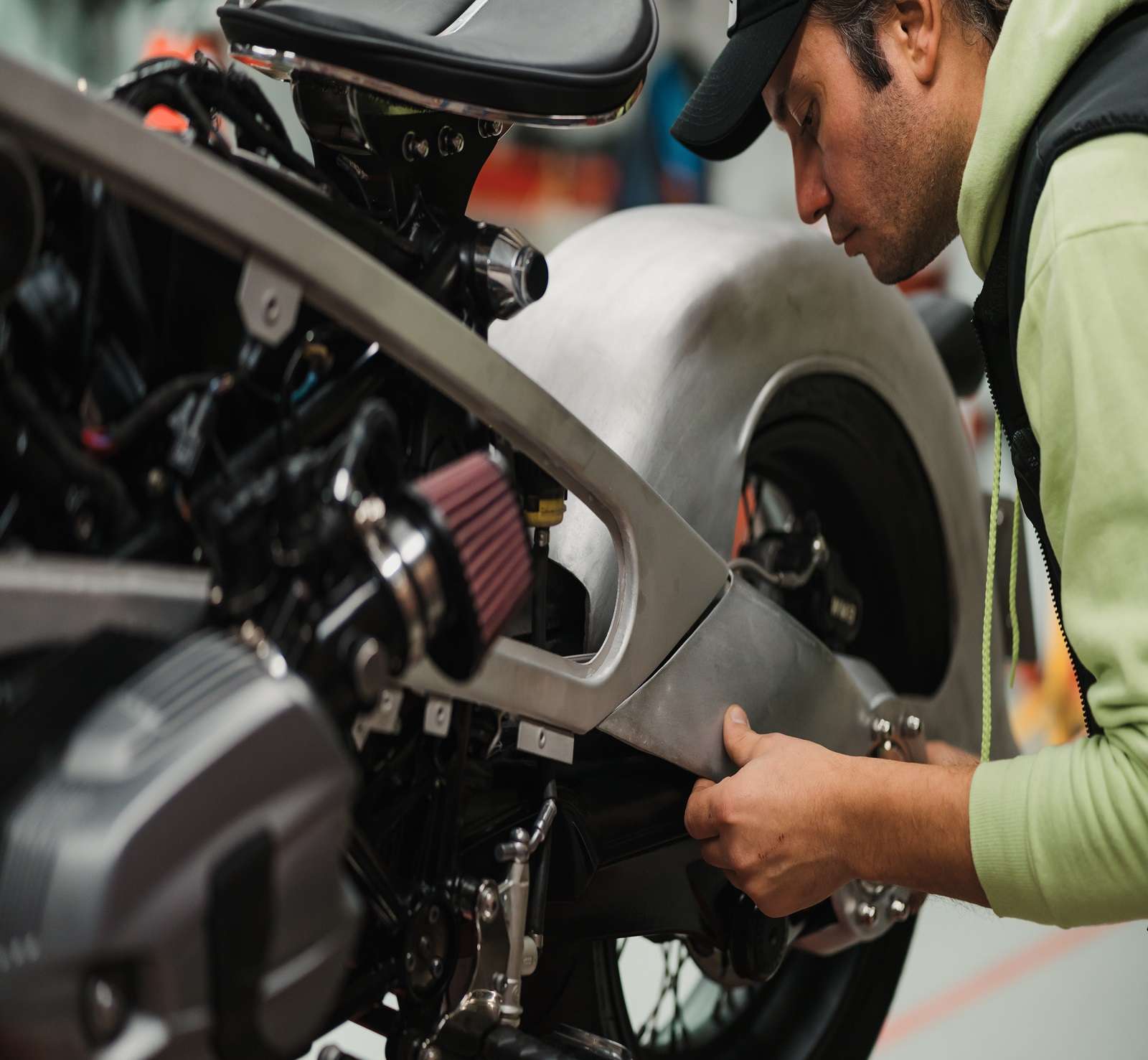 Repairman repair motorcycle, maintenance in garage. Mechanic fixing bike in a modern shop